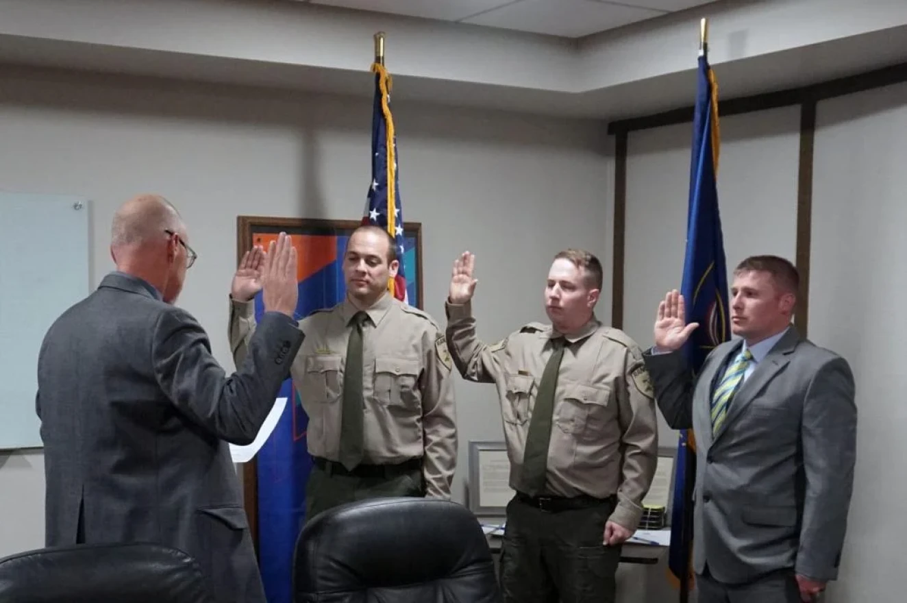 From left to right, park Rangers O’Mealy, Williams, and Agin are sworn in by Jeff Rasmussen, Director of the Division of Utah State Parks.